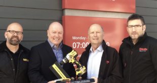 DeWalts General Sales Manager Mick Gill presents a 175th anniversary commemorative trophy to Elliotts Chariman Stuart Mason Elliott