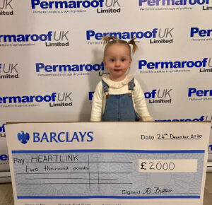River Mai Bishop granddaughter of Permagroup managing director Adrian Buttress presents a donation of 2000 to Heart Link Childrens Charity
